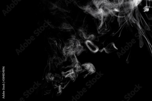 Fototapeta Naklejka Na Ścianę i Meble -  Abstract moving cloud of smoke. Thick smoke isolated on black background. Alchemy and magic concept. 
