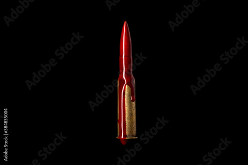 Photo A rifle bullet with red blood