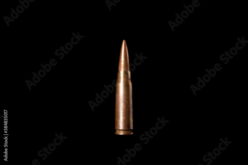 Bullet isolated on black background with reflexion. Rifle bullets close-up on black back. Cartridges for rifle and carbine on a black. Violence concept.