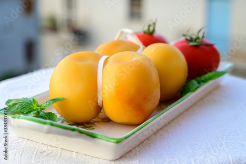 Cheese collection, Italian cheese scamorza made from cow milk in South Italy, white and yellow smoked.