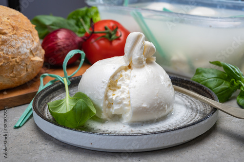 Tableau sur toile Eating of fresh handmade soft Italian cheese from Puglia, white balls of burrata