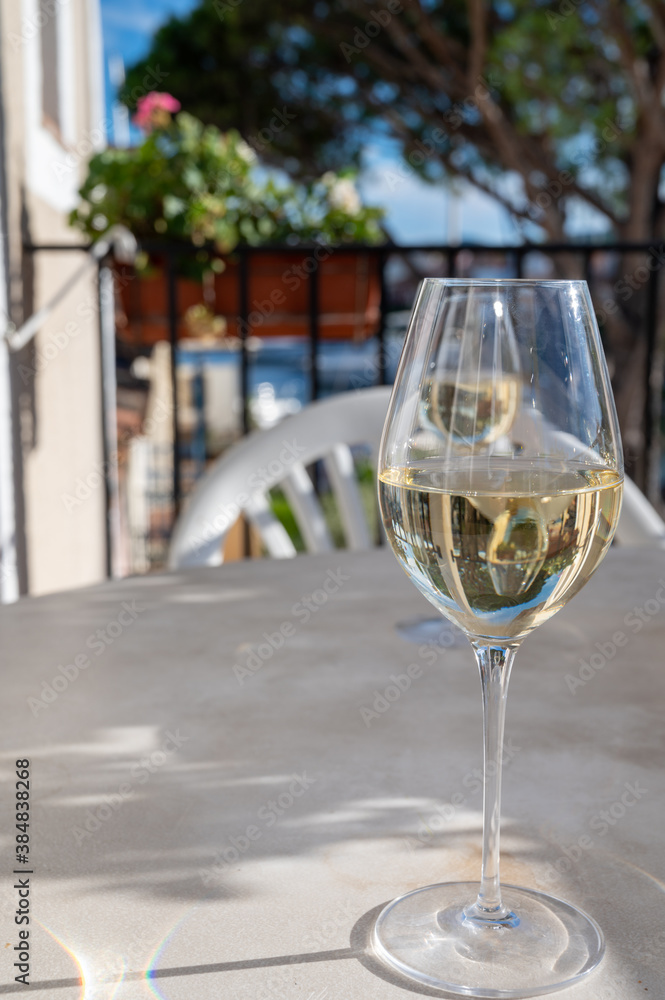 Tasting of local white wine on sunny summer balcony Provence, France Tasting of local white wine on sunny summer balcony Provence, France