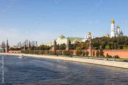 view of Kremlin embankment of Moskva River from Bolshoy Moskvoretsky Bridge on sunny autumn day photo