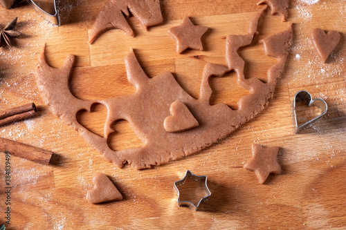 Cutting out pastry shapes for gingerbread Christmas cookies