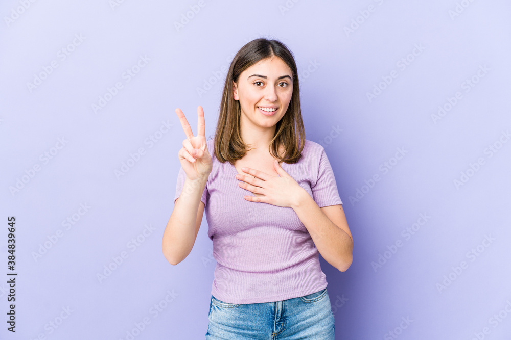 Young caucasian woman taking an oath, putting hand on chest. Young caucasian woman taking an oath, putting hand on chest.