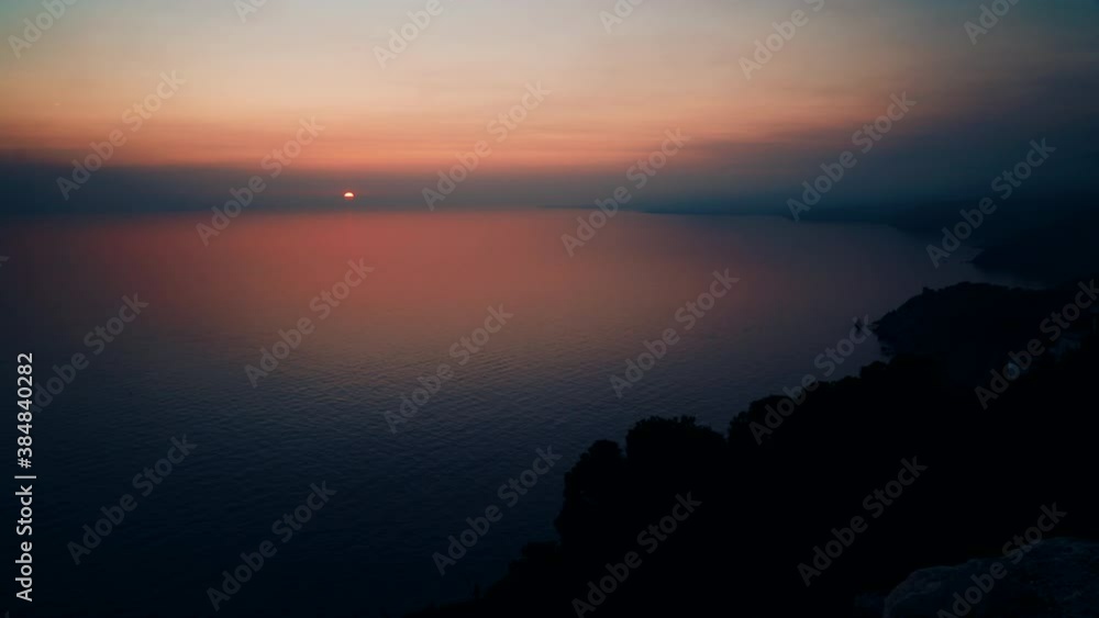 Time lapse of sunset over sea coast. Night is falling. View from cliffs Maro Cerro Gordo Natural Park, Malaga province, Costa Del Sol, Andalusia, Spain. Time lapse of sunset over sea coast. Night is falling. View from cliffs Maro Cerro Gordo Natural Park, Malaga province, Costa Del Sol, Andalusia, Spain.