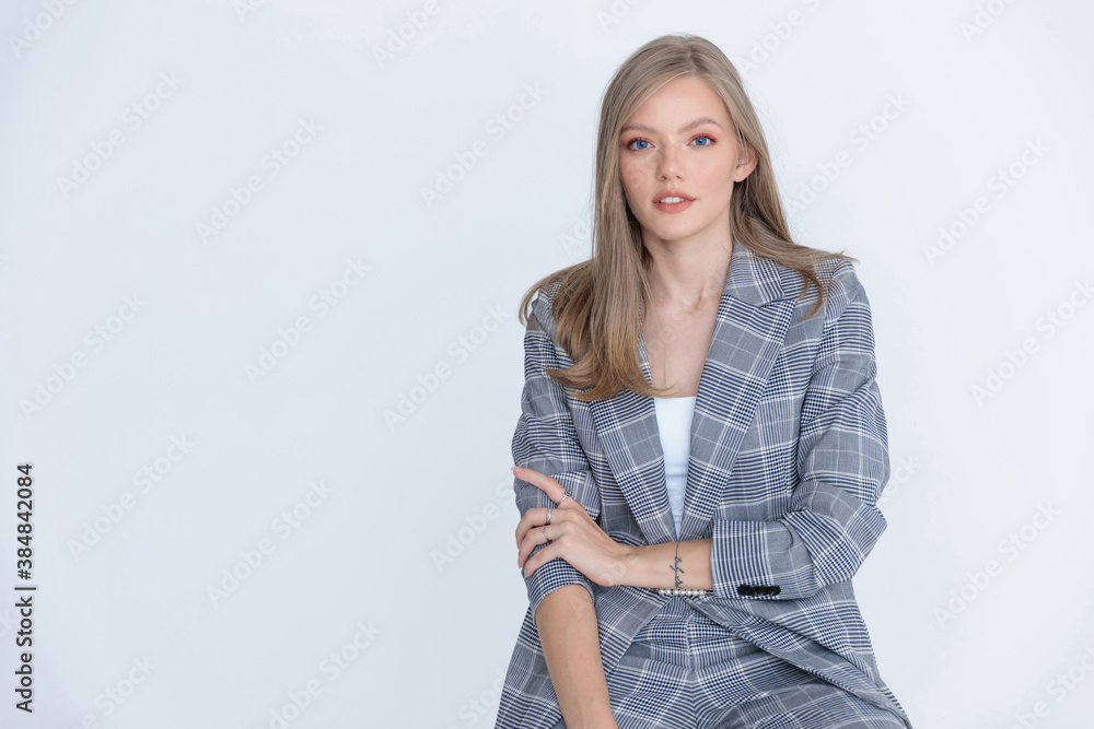 Positive businesswoman wearing suit and sitting Positive businesswoman wearing suit and sitting