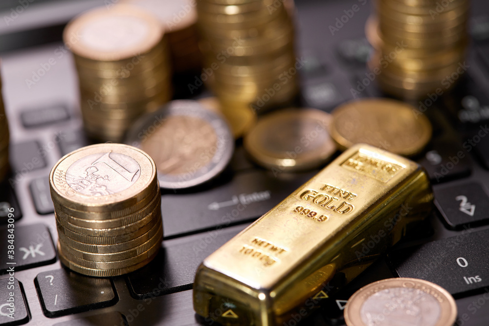 money coins on laptop computer money coins on laptop computer