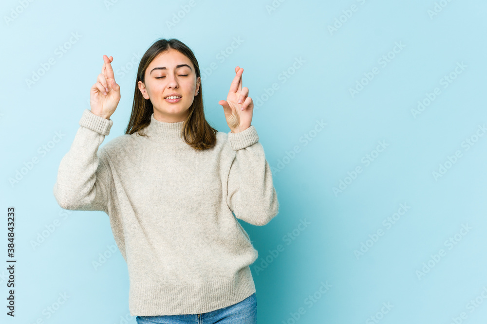 Young caucasian woman crossing fingers for having luck Young caucasian woman crossing fingers for having luck