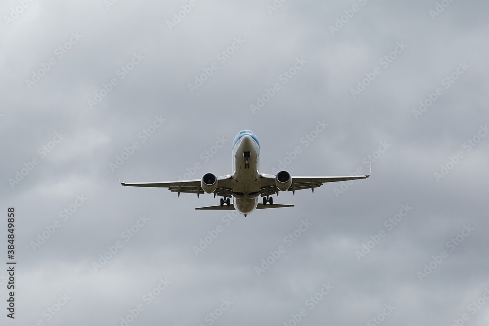 Plane approaching landing in cloudy overcast weather Plane approaching landing in cloudy overcast weather