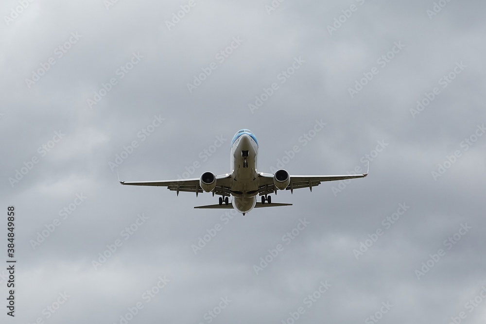 Plane approaching landing in cloudy overcast weather