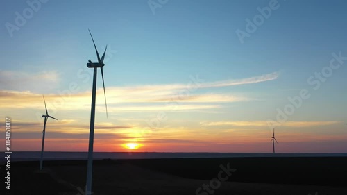 Eolian turbines park at sunet, warm light. Wind power concept
