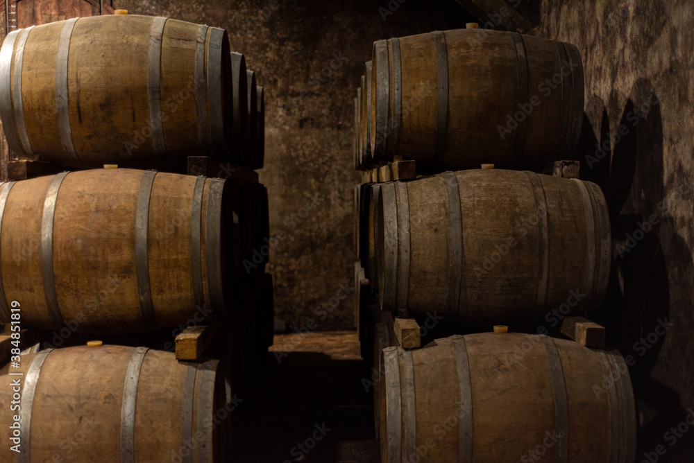 Wooden barrels for wine aging in the cellar. Italian wine. Wooden barrels for wine aging in the cellar. Italian wine.
