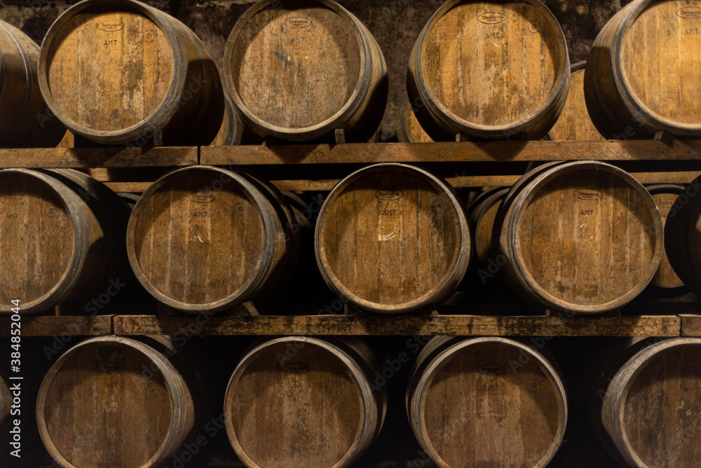Wooden barrels for wine aging in the cellar. Italian wine.