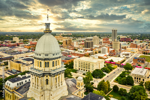 Photo Aerial view of the Illinois State Capitol dome and Springfield skyline under a dramatic sunset