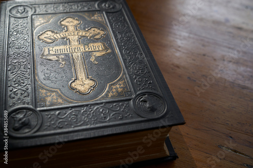 old family bible black book with gold applications, text on cover illustrated family bible