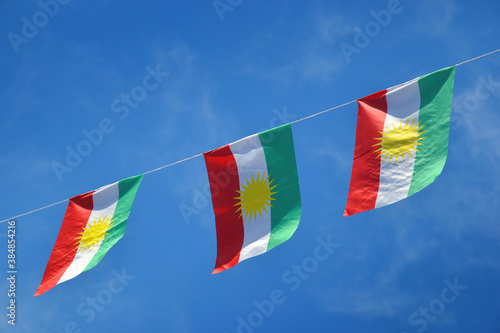 Iraqi Kurdish flag, three side by side in the blue sky photo
