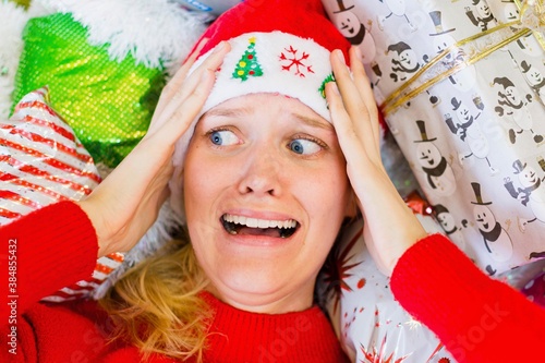 A woman worried and stressed out during the holiday season. Christmas gift shopping.