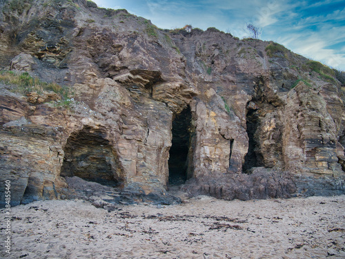 Caves in eroded mudstone cliffs at Runswick Bay in North Yorkshire, UK - part of the Whitby Mudstone Formation - sedimentary bedrock formed in the Jurassic Period