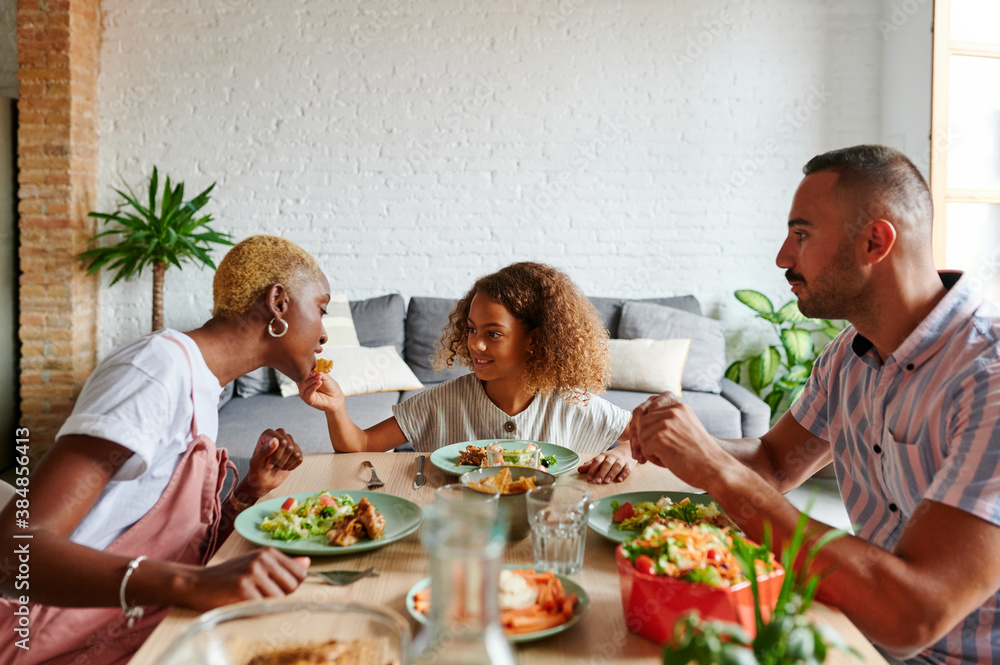 Laughing family having dinner