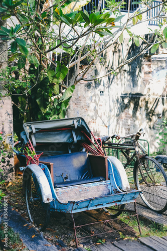 An old battered rickshaw photo