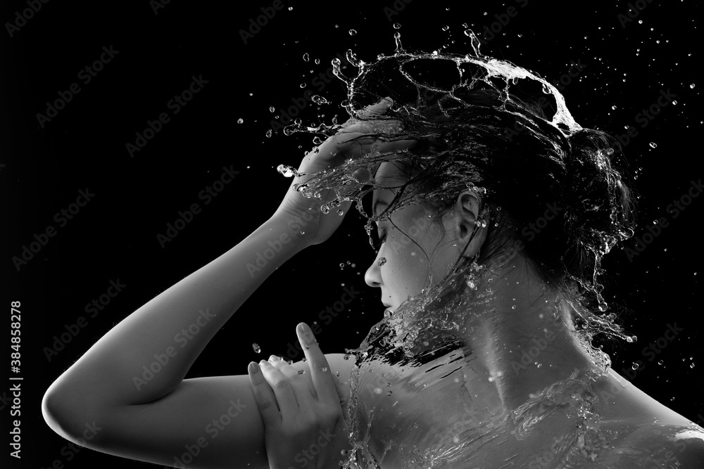  young woman with clean skin and splash of water. Portrait of woman with drops of water around her face black and white