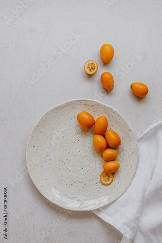 Kumquats on light background photo