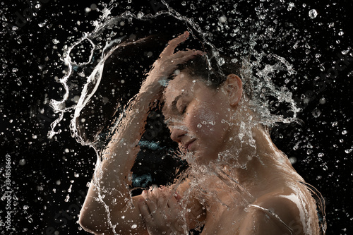  young woman with clean skin and splash of water Portrait of woman with drops of water around her face
