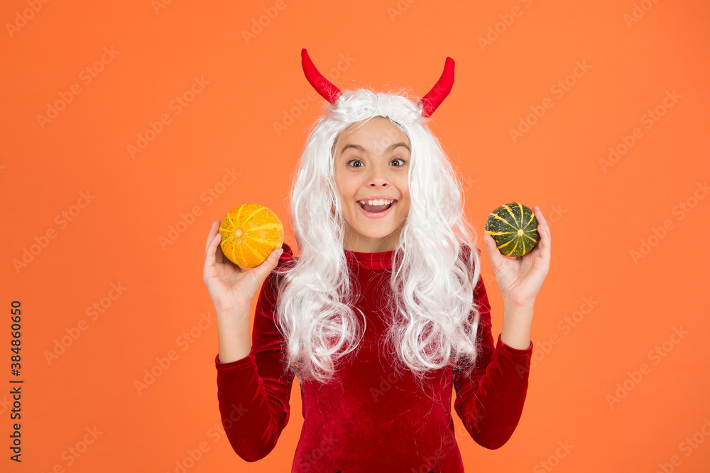 amazed devil teenage girl with white hair hold pumpkin vegetable wear horns costume of imp on halloween party, happy halloween