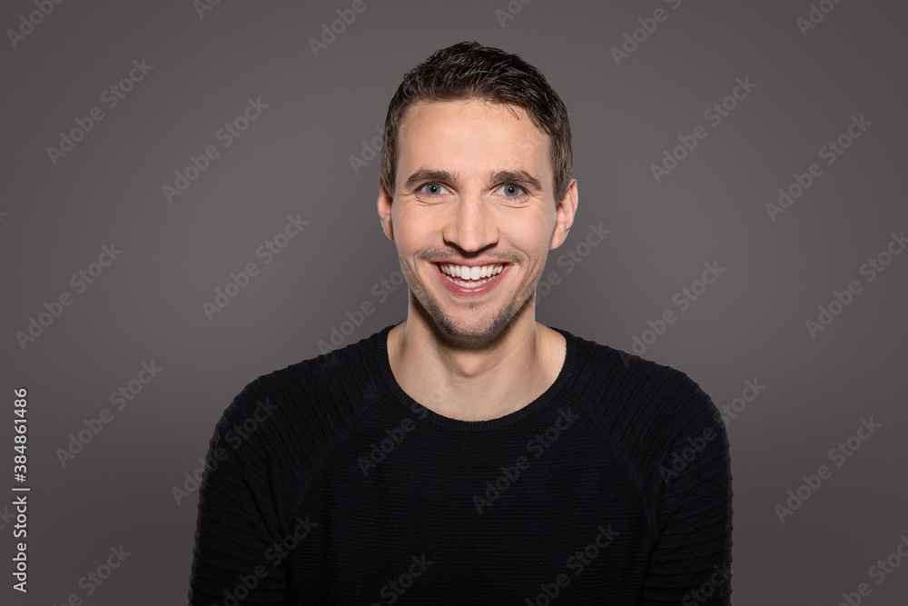 humorous happy man laughing intro camera with open mouth showing his teeth while reacting to funny situation humorous happy man laughing intro camera with open mouth showing his teeth while reacting to funny situation