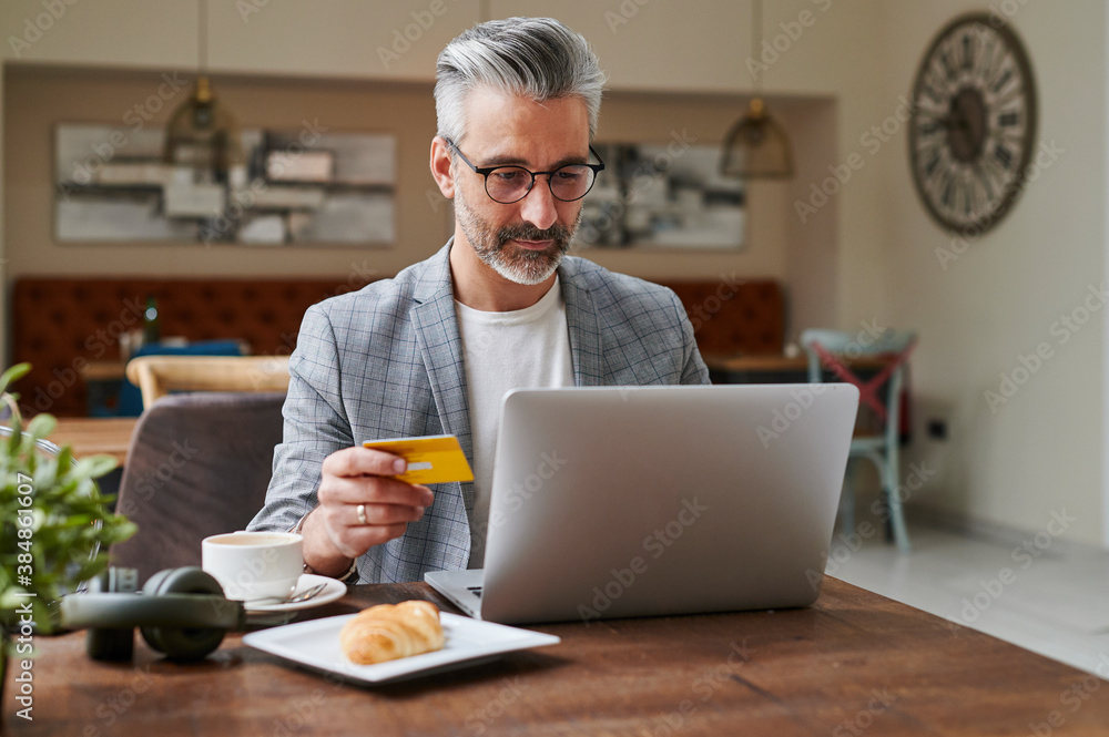 Businessman online shopping during a break Businessman online shopping during a break