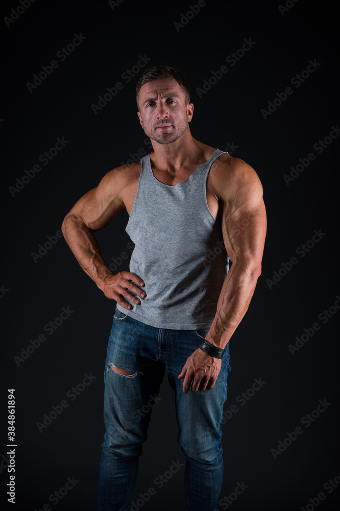 Hustle to gain more muscle. Fit guy with muscular arms black background. Sportsman show biceps triceps in casual wear. Training muscular strength. Bodybuilding and mens physique. Sport and fitness Hustle to gain more muscle. Fit guy with muscular arms black background. Sportsman show biceps triceps in casual wear. Training muscular strength. Bodybuilding and mens physique. Sport and fitness