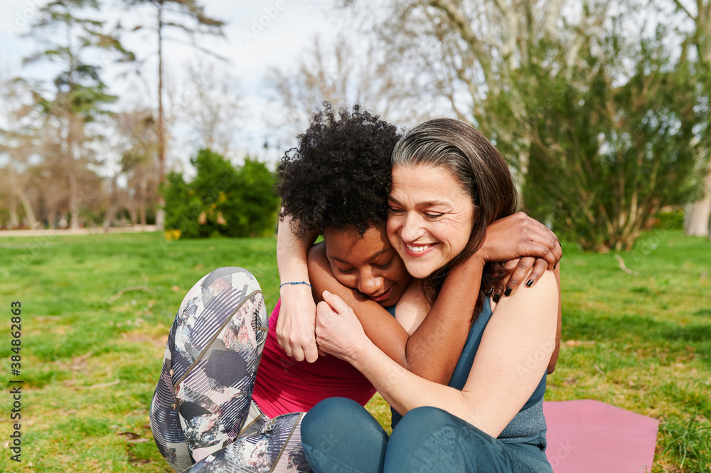 Laughing women sitting outside after yoga Laughing women sitting outside after yoga