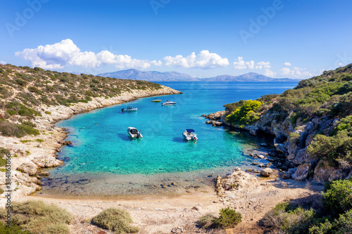 A small beach on the little island of Fleves, close to Athens, with turquoise sea and people enjoying the sun, Greece