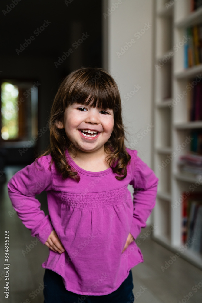 Excited little girl with hands on waist Excited little girl with hands on waist