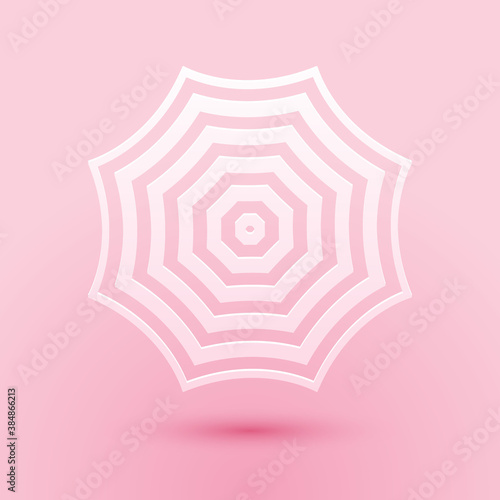 Paper cut Sun protective umbrella fo beach icon isolated on pink background. Large parasol for outdoor space. Summer vacation or picnic accessory. Paper art style. Vector.