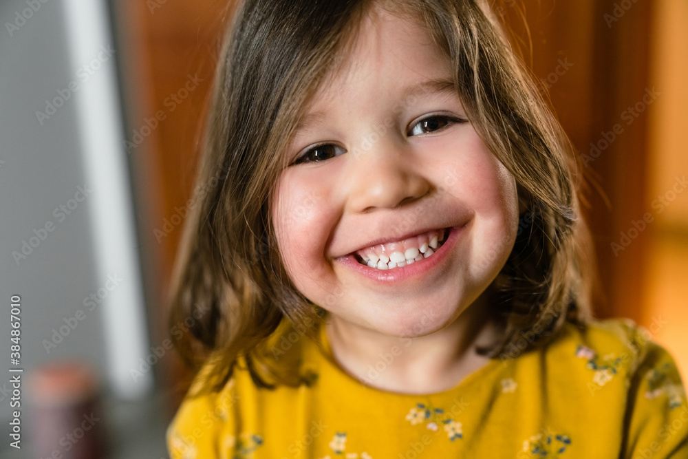 Crop smiling little child in casual clothes at home Crop smiling little child in casual clothes at home