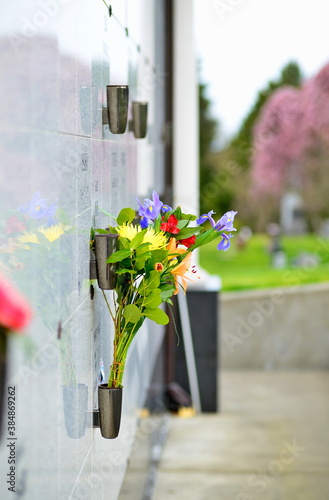 Obraz na plátně Flowers in a vase on the mausoleum wall