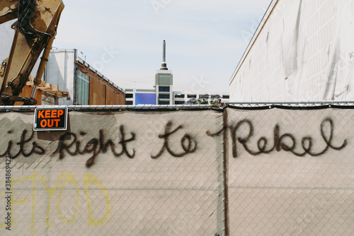 Protest graffiti on city fence during riot looting