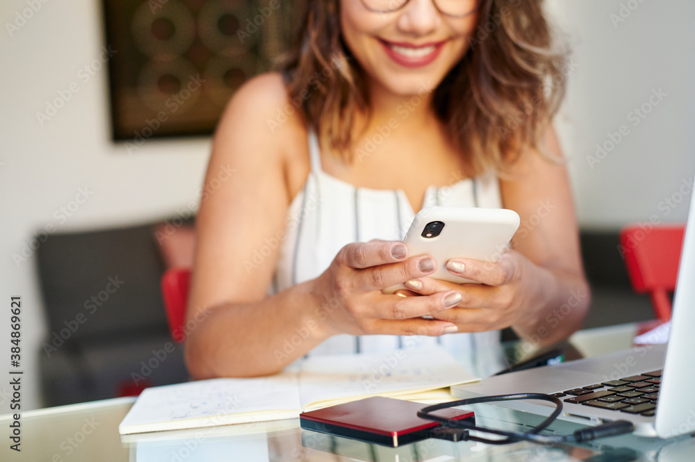 Smiling businesswoman texting on her phone Smiling businesswoman texting on her phone