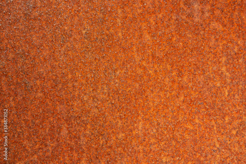 The background is a rusty orange metal surface for an inscription or banner. Pattern textured rust surface  © ANDREY PROFOTO