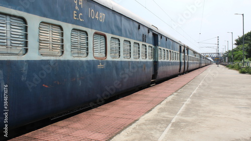 indian railway train in platform, Indian Railways carries about 7,500 million passengers annually.