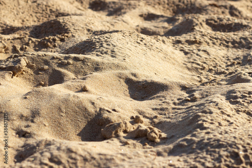 Uneven surface of sand on the beach at the seaside on a sunny day.