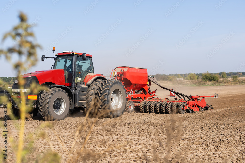 The tractor harvester working on the field The tractor harvester working on the field