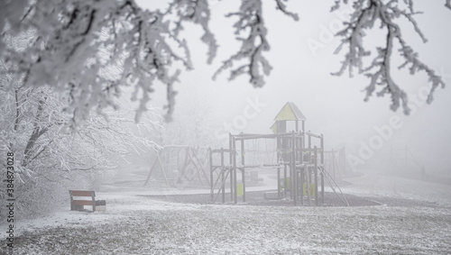Playground in winter covere...