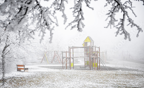Playground in winter covere...