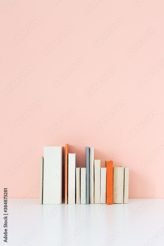 Books on a bookshelf and pink wall. Books on a bookshelf and pink wall.