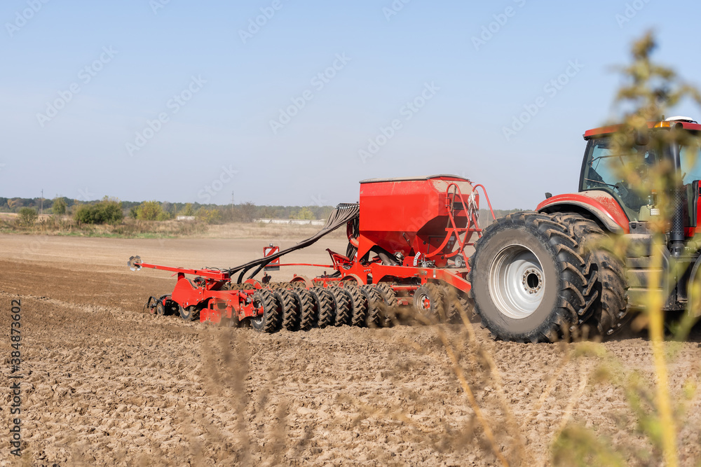 Obraz premium Tractor cultivating soil and preparing a field for planting