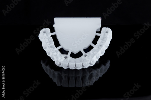 Milled raw zircon dental prosthesis for patient after milling machine, lower jaw.