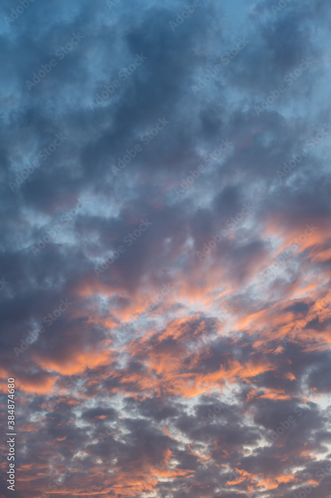 sunset sky with clouds vertical background. Clouds on a hot summer day.